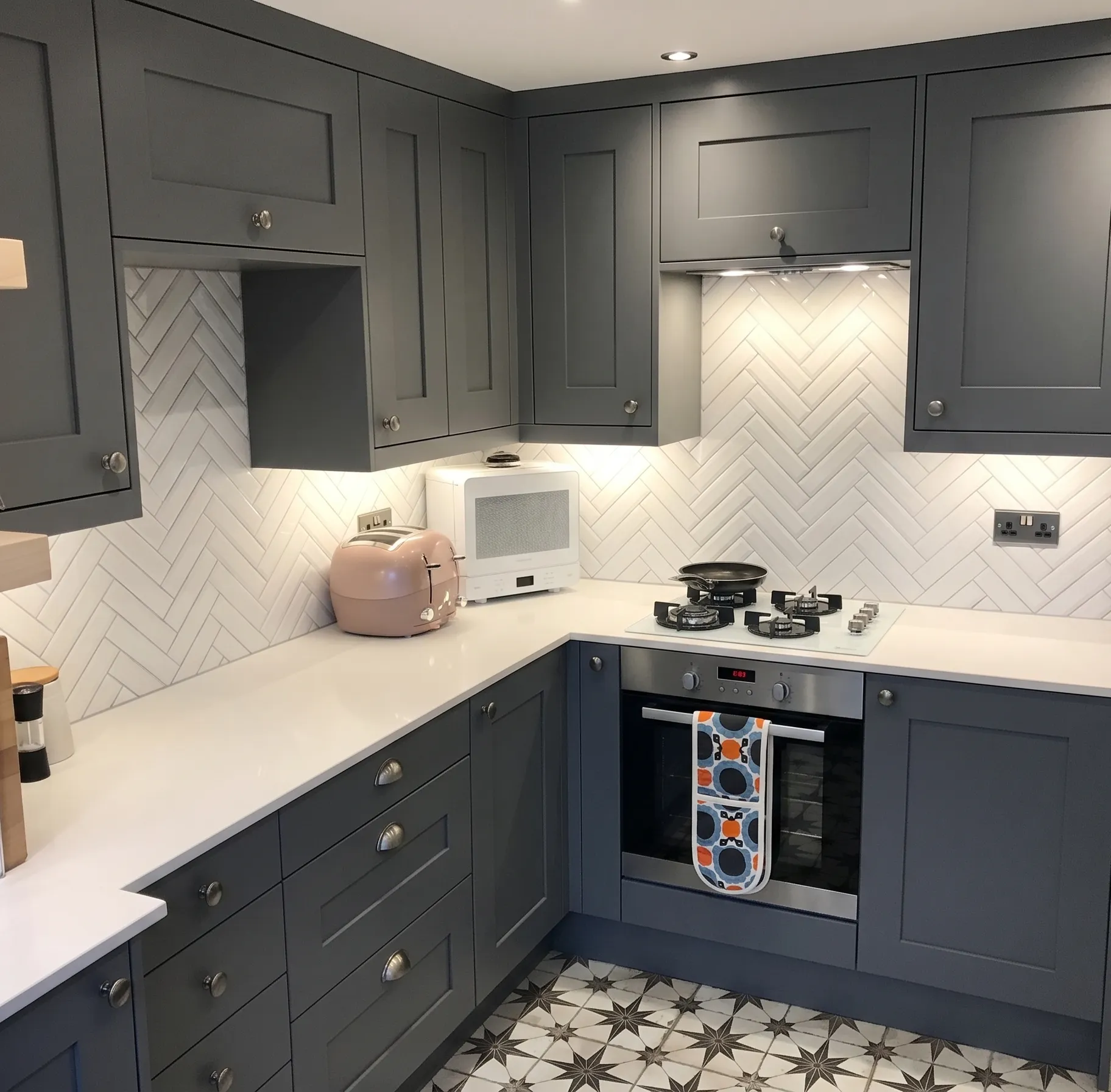 A clean kitchen with clear, wiped-down worktops.